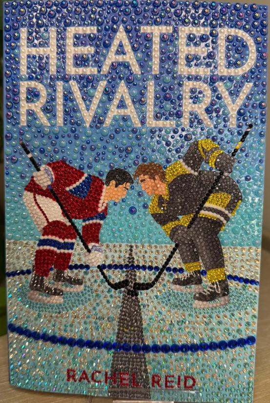 Decorative book cover detail in warm pink and red tones